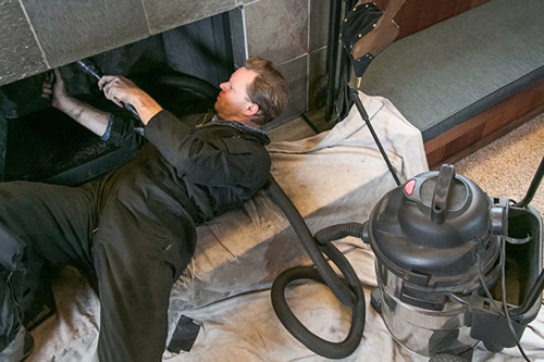 Chimney inspector cleaning the chimney